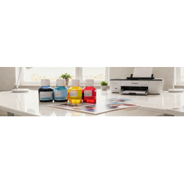Encreurs colorés Sudhaus pour Canon G3500: cinq flacons de 100 ml (noir, cyan, jaune, magenta) alignés sur une table près d’une